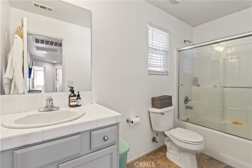 2614 Bellevue Way Palmdale, CA 93550 - Photo 24 of 28 a bathroom with a sink toilet and shower