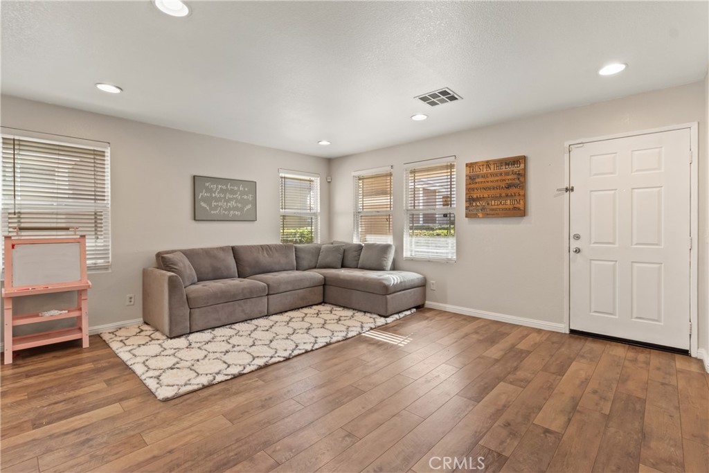 2614 Bellevue Way Palmdale, CA 93550 - Photo 6 of 28 a living room with furniture and wooden floor