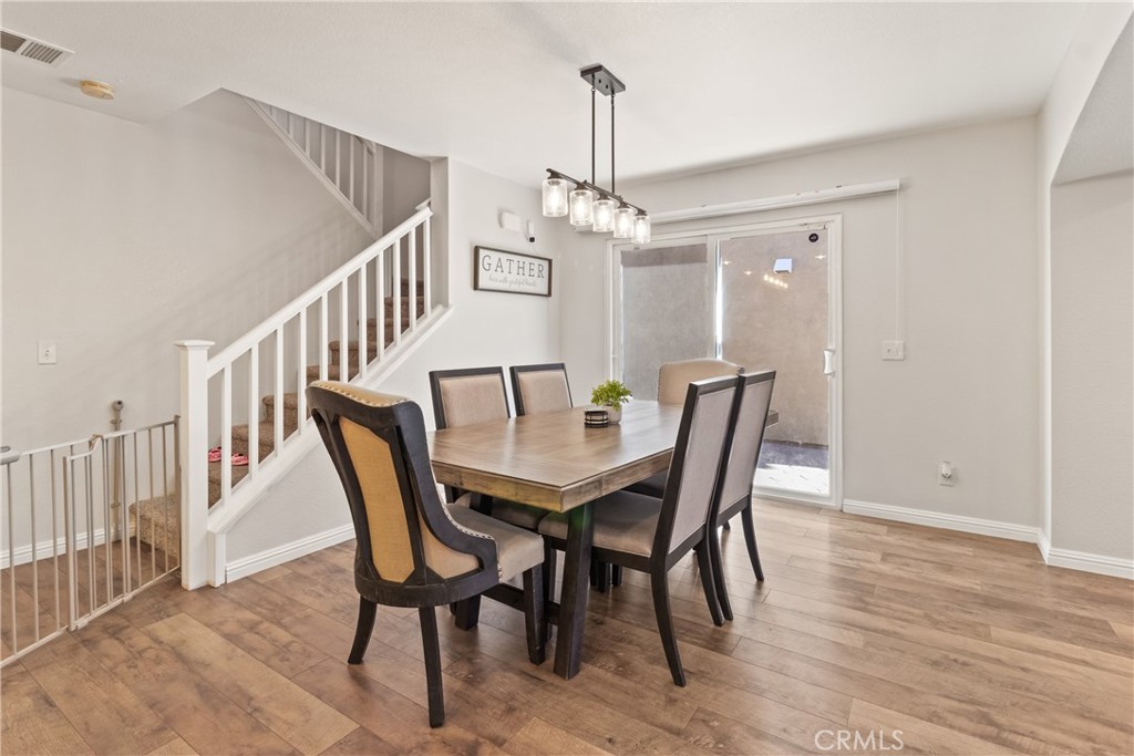 2614 Bellevue Way Palmdale, CA 93550 - Photo 10 of 28 a view of a dining room with furniture and wooden floor