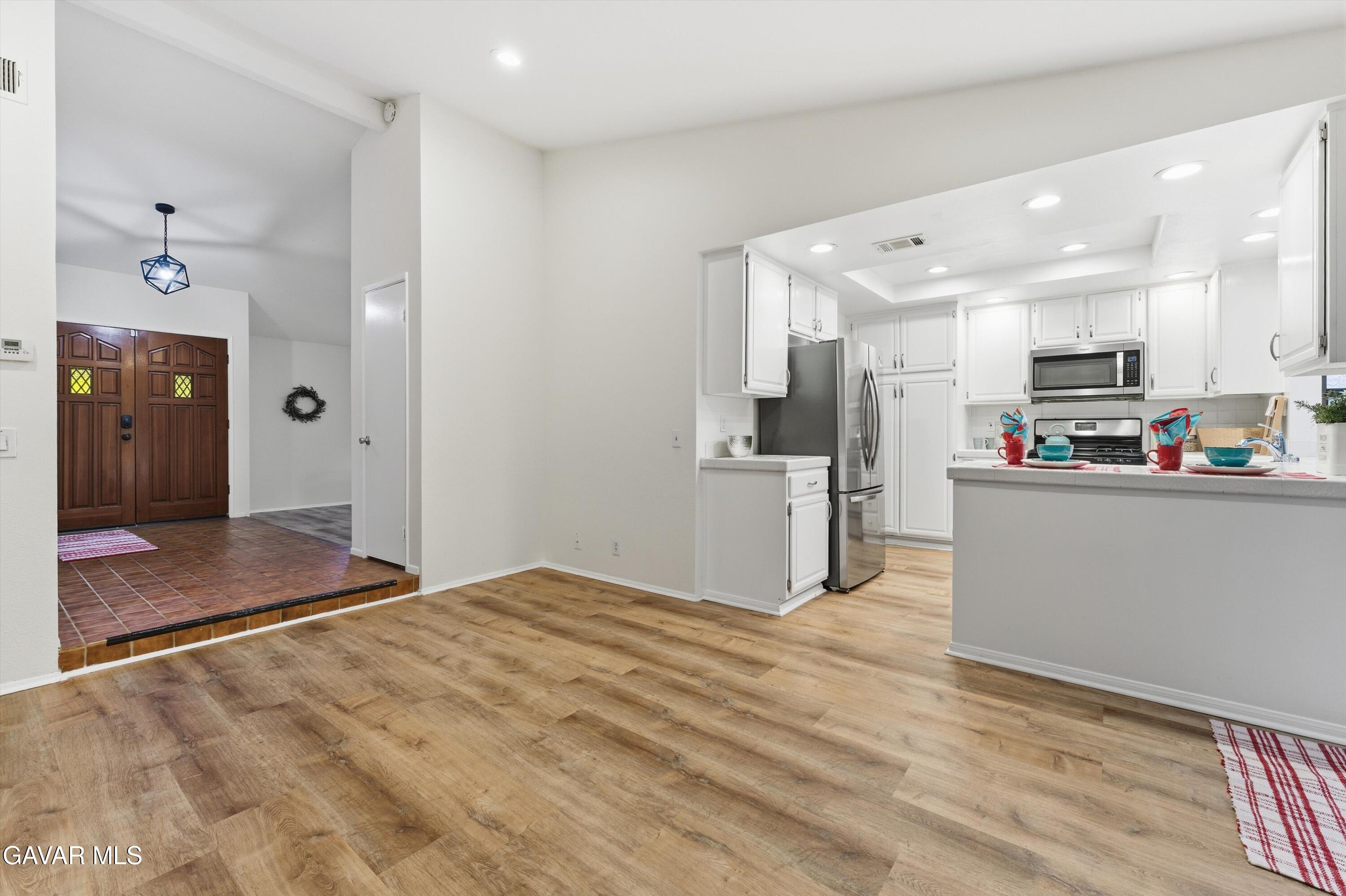 13611 Bear Valley Road Moorpark, CA 93021 - Photo 15 of 21 a kitchen view with stainless steel appliances kitchen island granite countertop a refrigerator and a sink