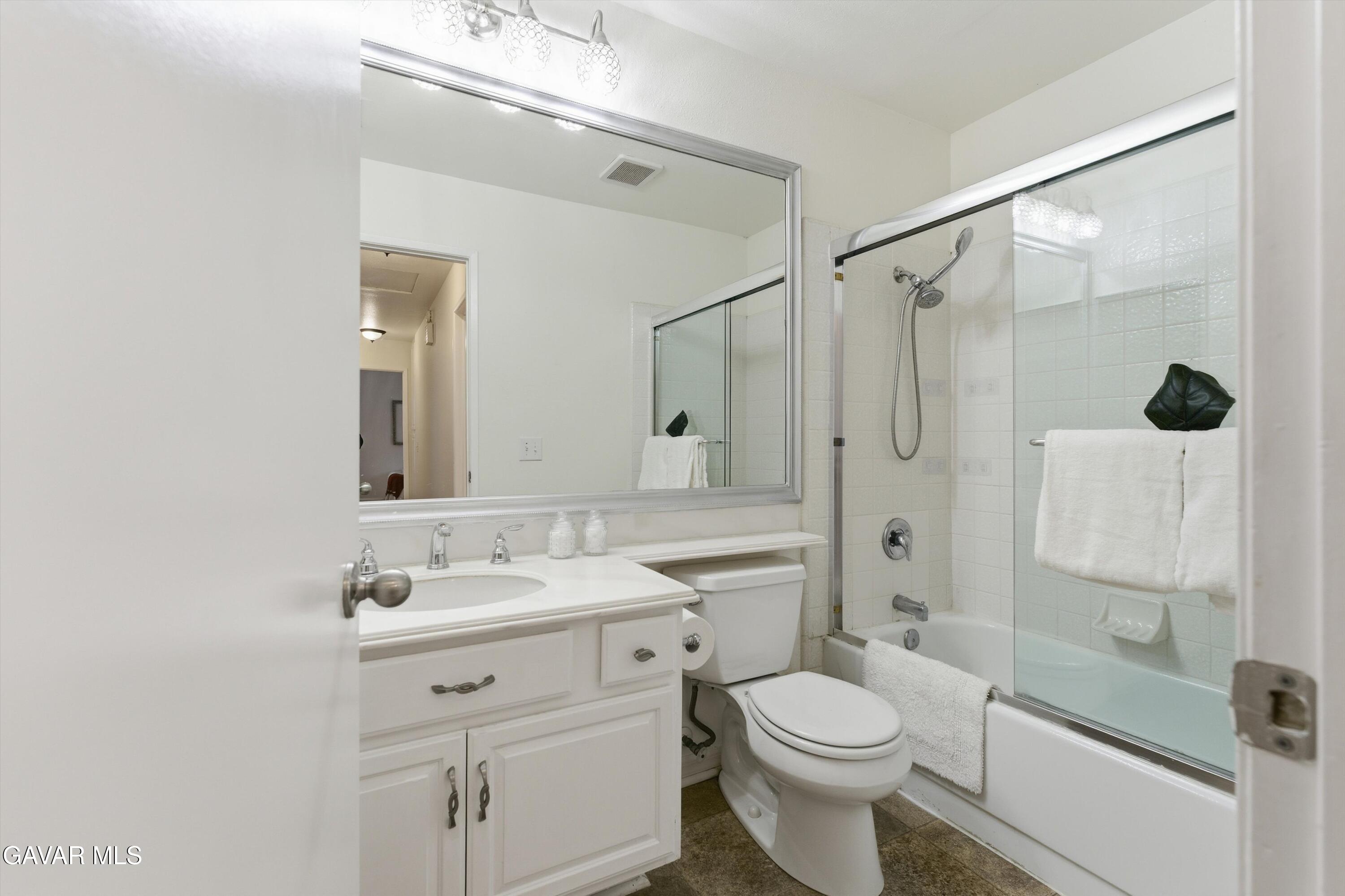 13611 Bear Valley Road Moorpark, CA 93021 - Photo 21 of 21 a bathroom with a sink toilet mirror and shower
