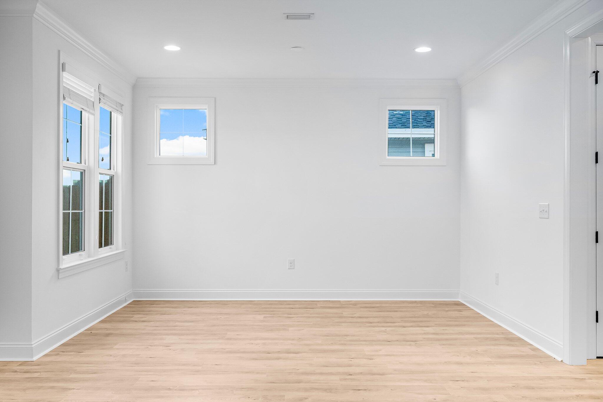 95 Conifer Ct Inlet Beach Inlet Beach, FL 32461 - Photo 12 of 33 an empty room with wooden floor and windows