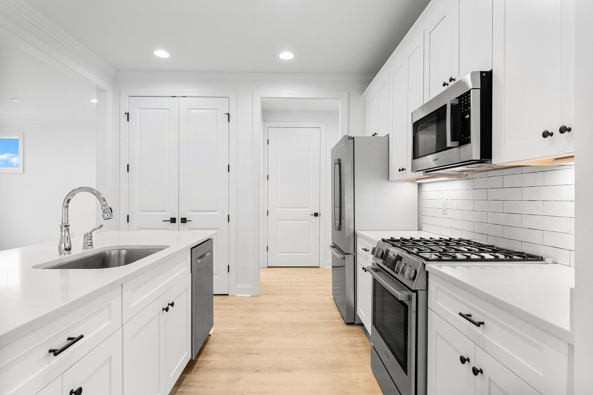 95 Conifer Ct Inlet Beach Inlet Beach, FL 32461 - Photo 9 of 33 a kitchen with stainless steel appliances kitchen island a white stove top oven and refrigerator