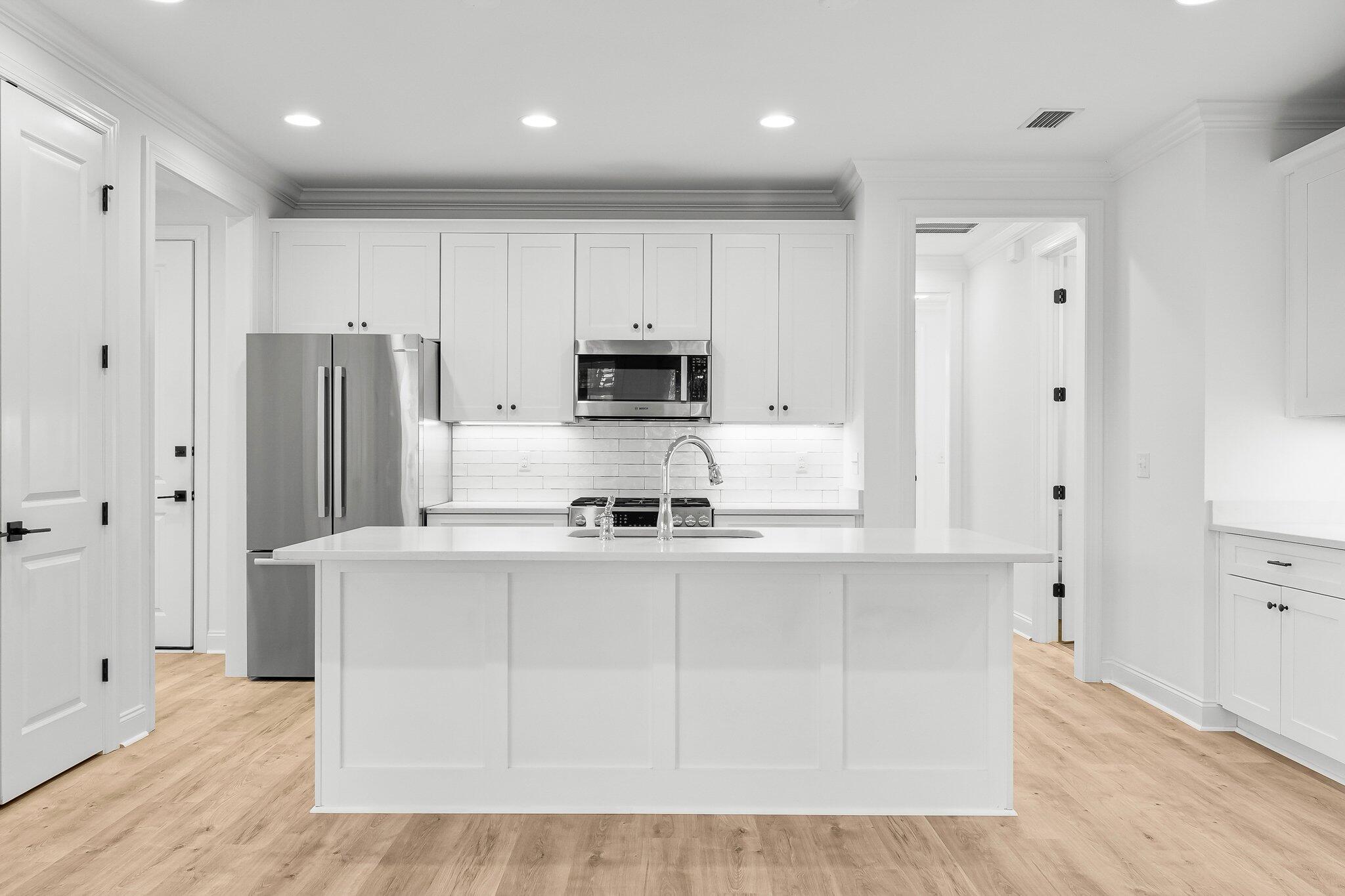 95 Conifer Ct Inlet Beach Inlet Beach, FL 32461 - Photo 10 of 33 a kitchen with stainless steel appliances granite countertop a refrigerator a stove a sink and white cabinets with wooden floor