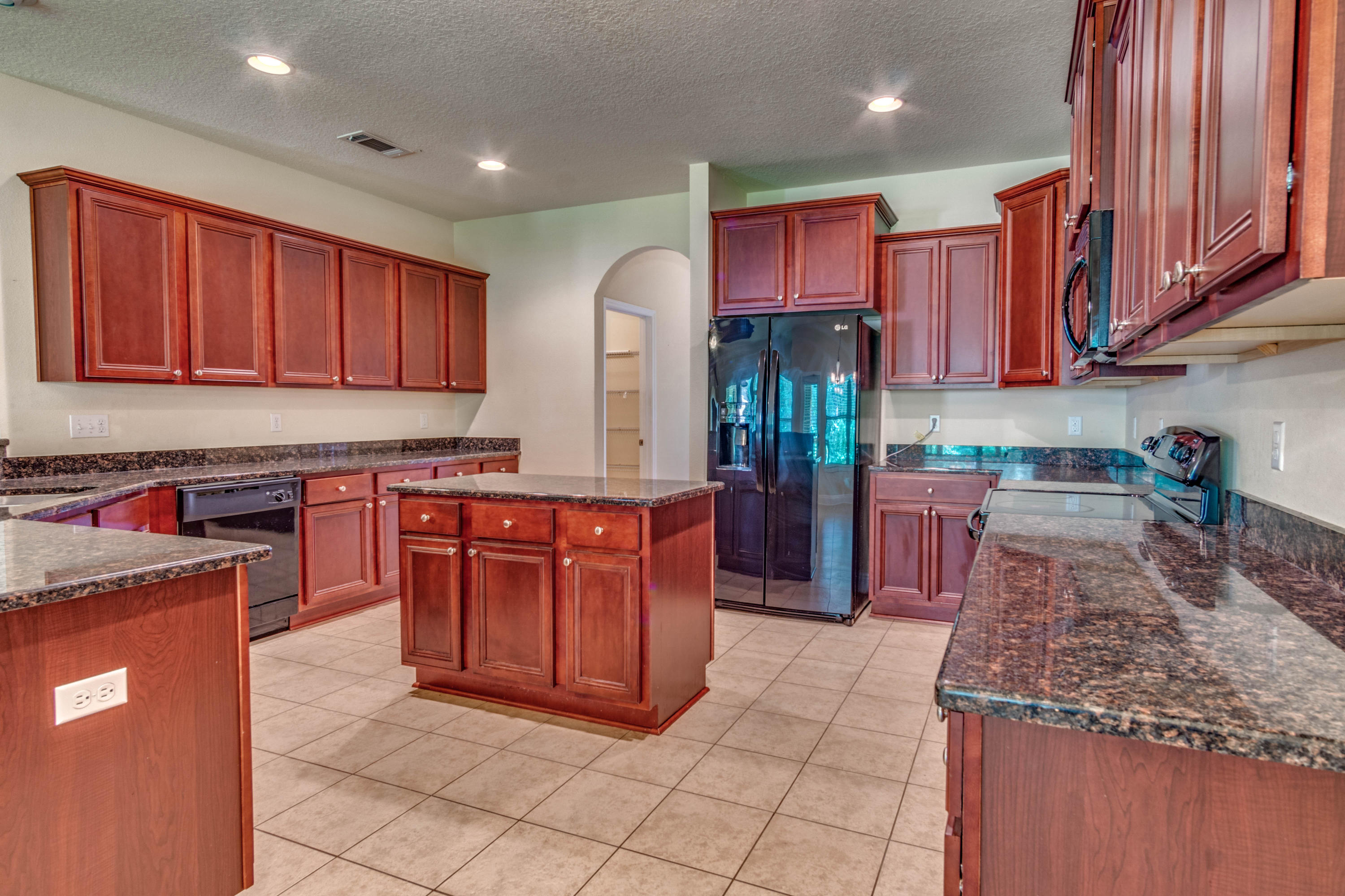642 Red Fern Road Crestview, FL 32536 - Photo 12 of 32 a kitchen with stainless steel appliances granite countertop a stove top oven a sink and dishwasher