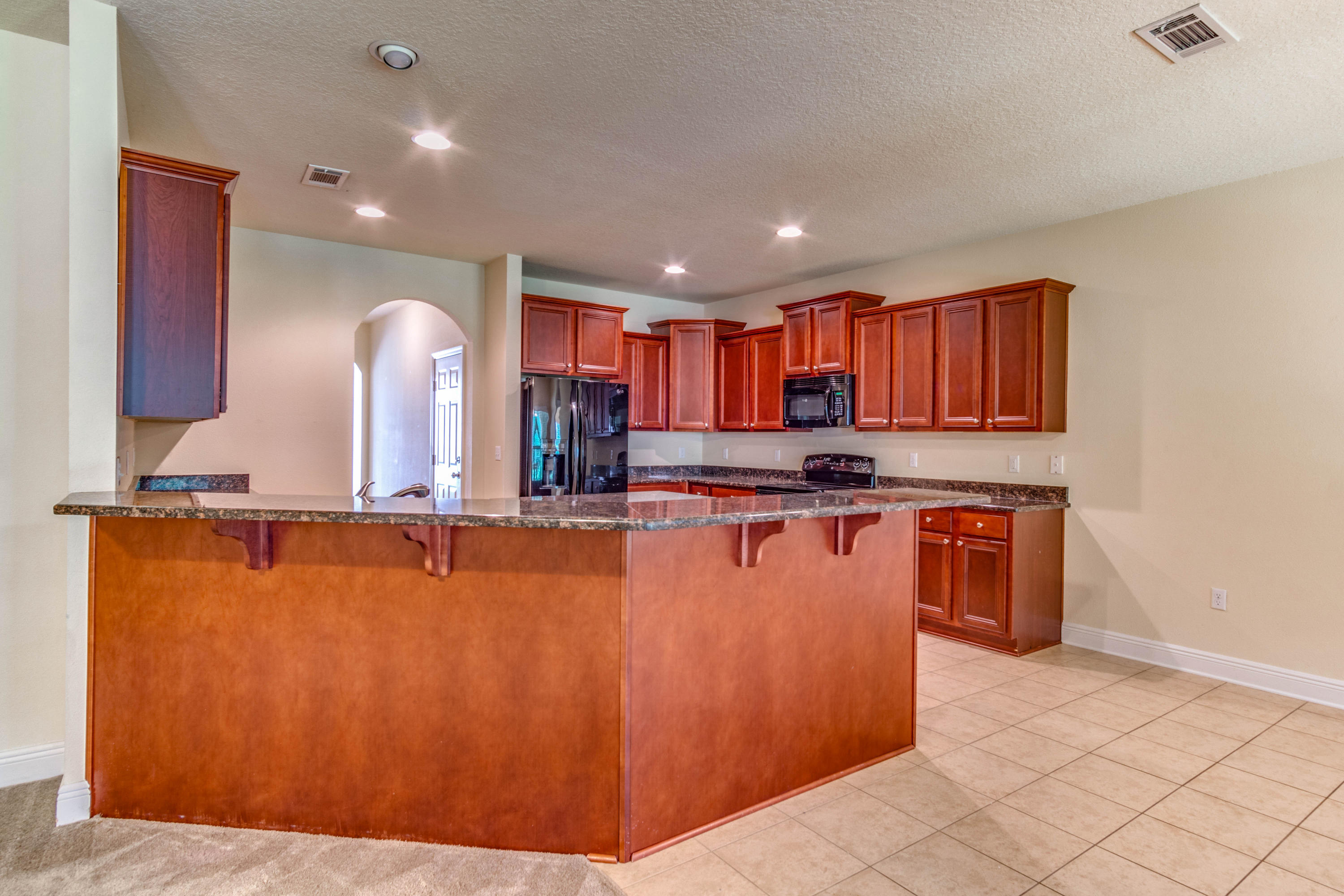 642 Red Fern Road Crestview, FL 32536 - Photo 13 of 32 a kitchen with stainless steel appliances granite countertop a refrigerator a sink and a stove
