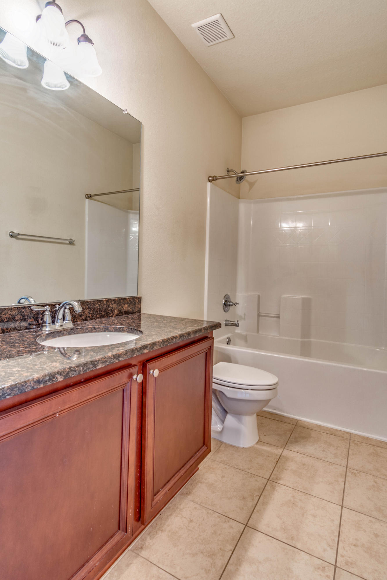 642 Red Fern Road Crestview, FL 32536 - Photo 21 of 32 a bathroom with a granite countertop sink toilet a mirror and bathtub