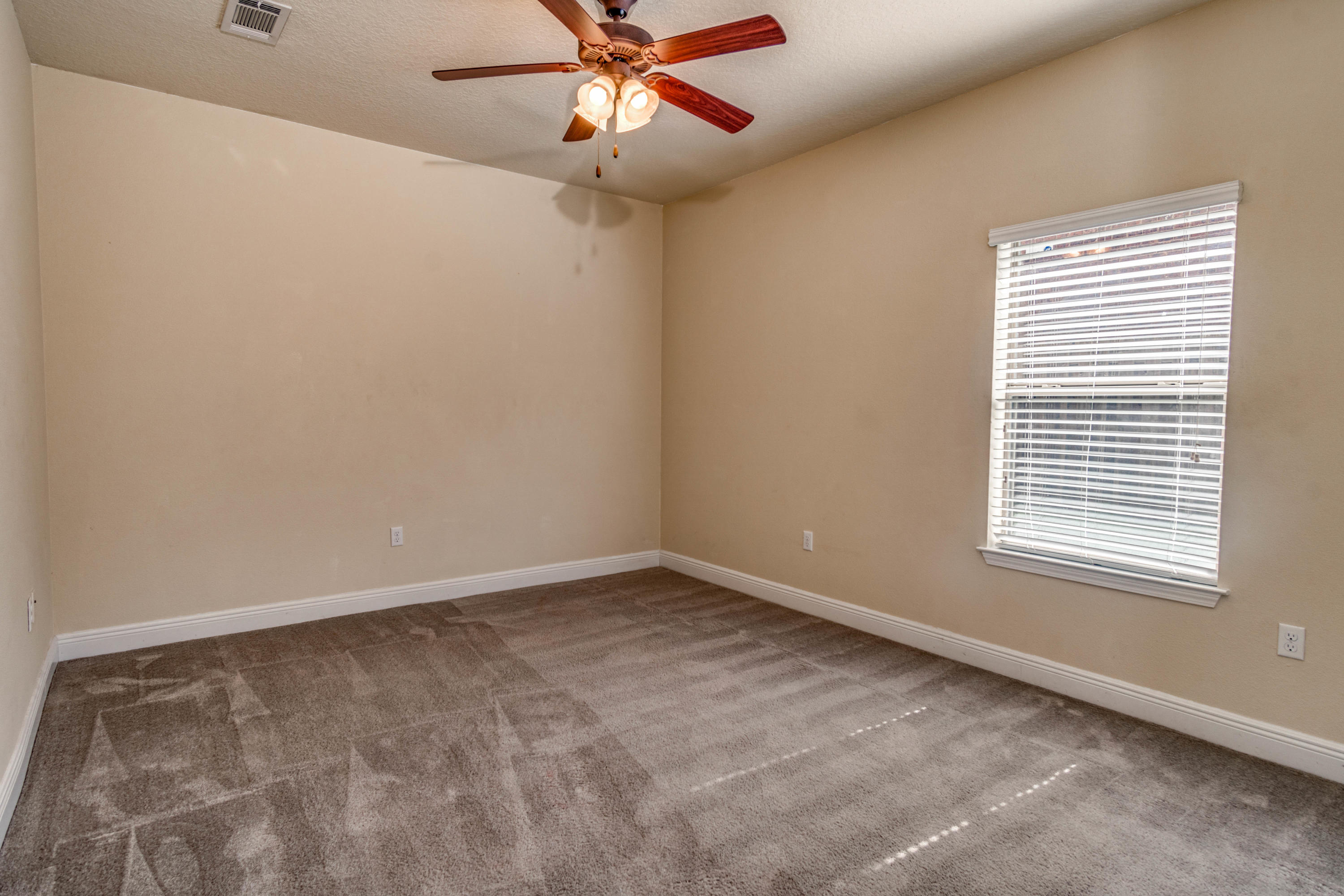 642 Red Fern Road Crestview, FL 32536 - Photo 25 of 32 an empty room with a window and a fan