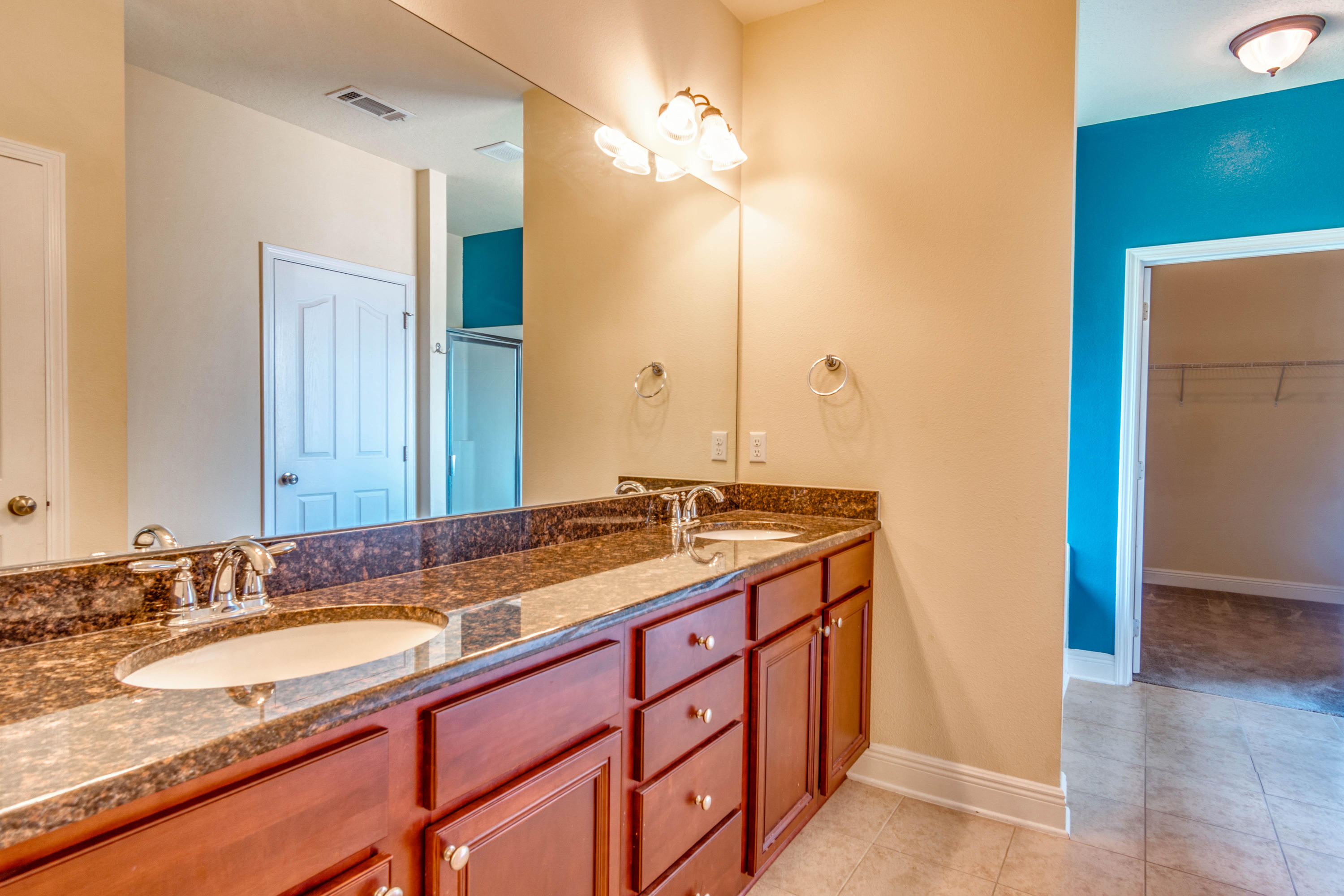 642 Red Fern Road Crestview, FL 32536 - Photo 28 of 32 a bathroom with a granite countertop sink and a mirror