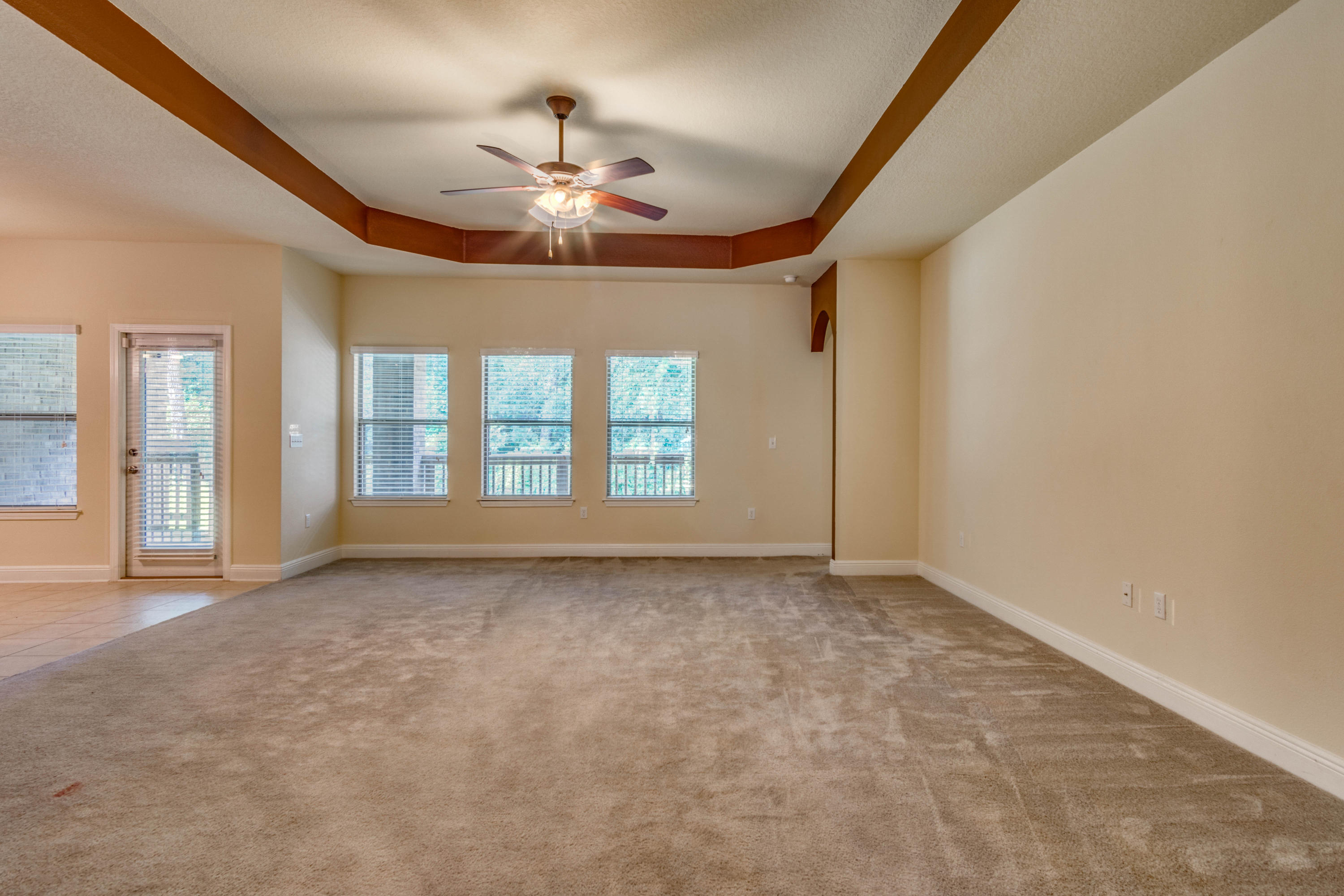 642 Red Fern Road Crestview, FL 32536 - Photo 10 of 32 a view of an empty room with chandelier fan and fire place