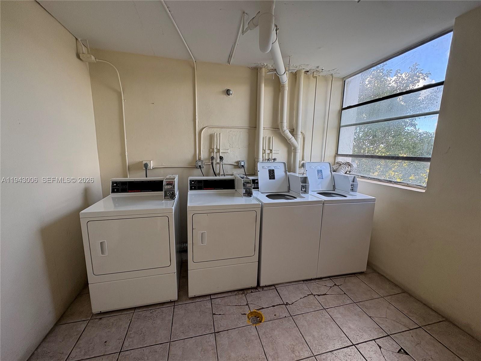 2401 Riverside Drive, Unit 314B Coral Springs, FL 33065 - Photo 13 of 16 a room with dryer and washer