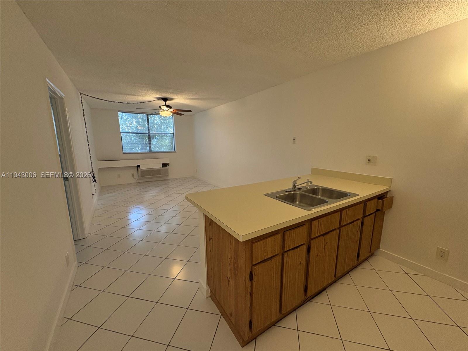 2401 Riverside Drive, Unit 314B Coral Springs, FL 33065 - Photo 2 of 16 a kitchen with a sink cabinets and utility