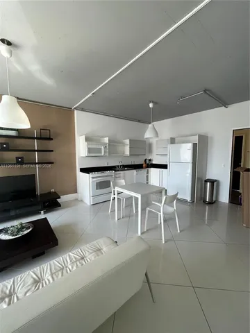 a kitchen with a table chairs and a stove