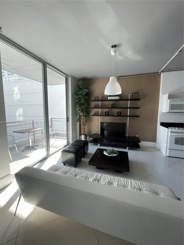 a room with furniture and a large window