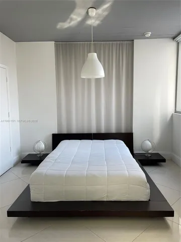 a bedroom with a bed and a lamp