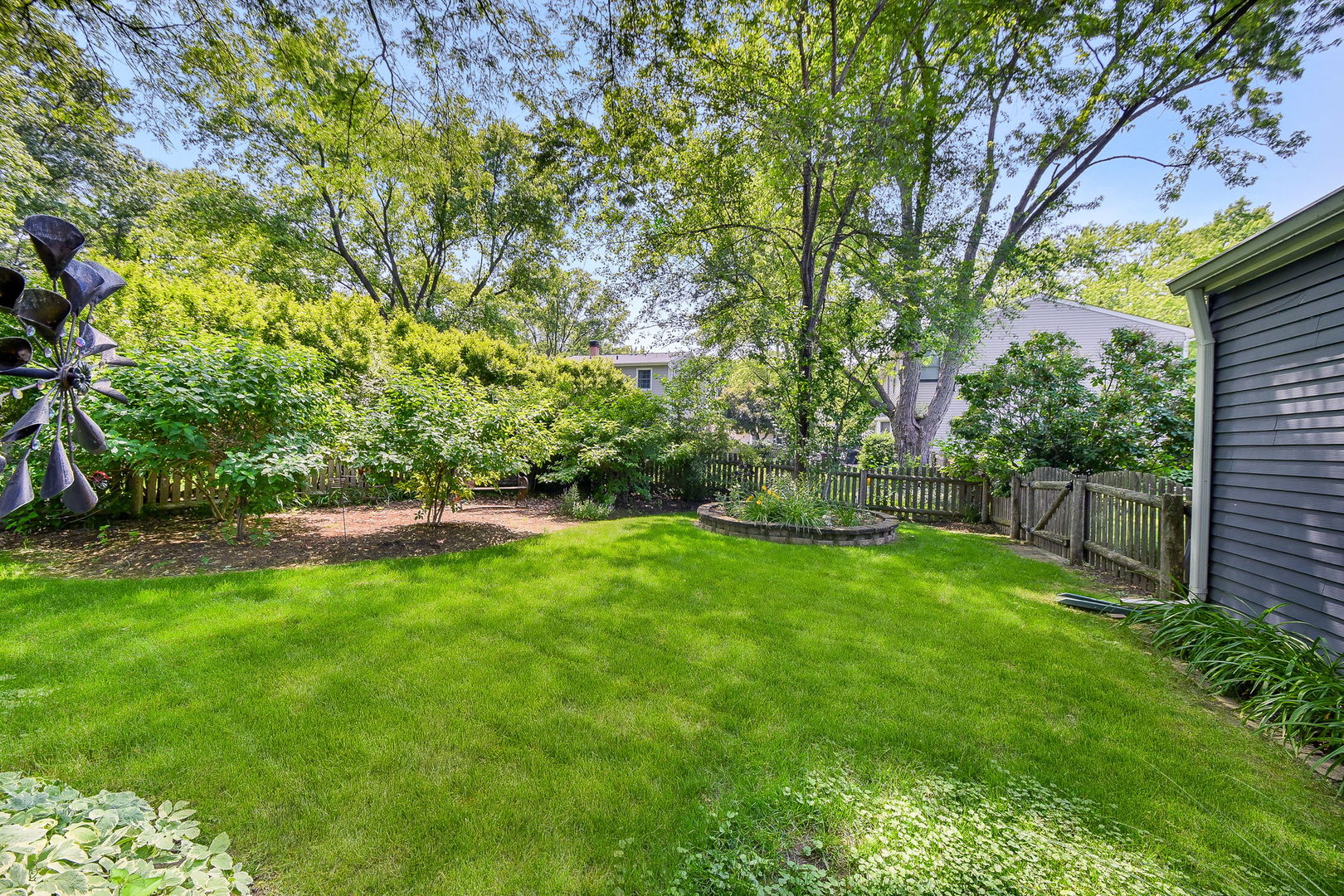 116 West Bailey Road Naperville, IL 60565 - Photo 21 of 27 a view of a backyard with potted plants and large trees