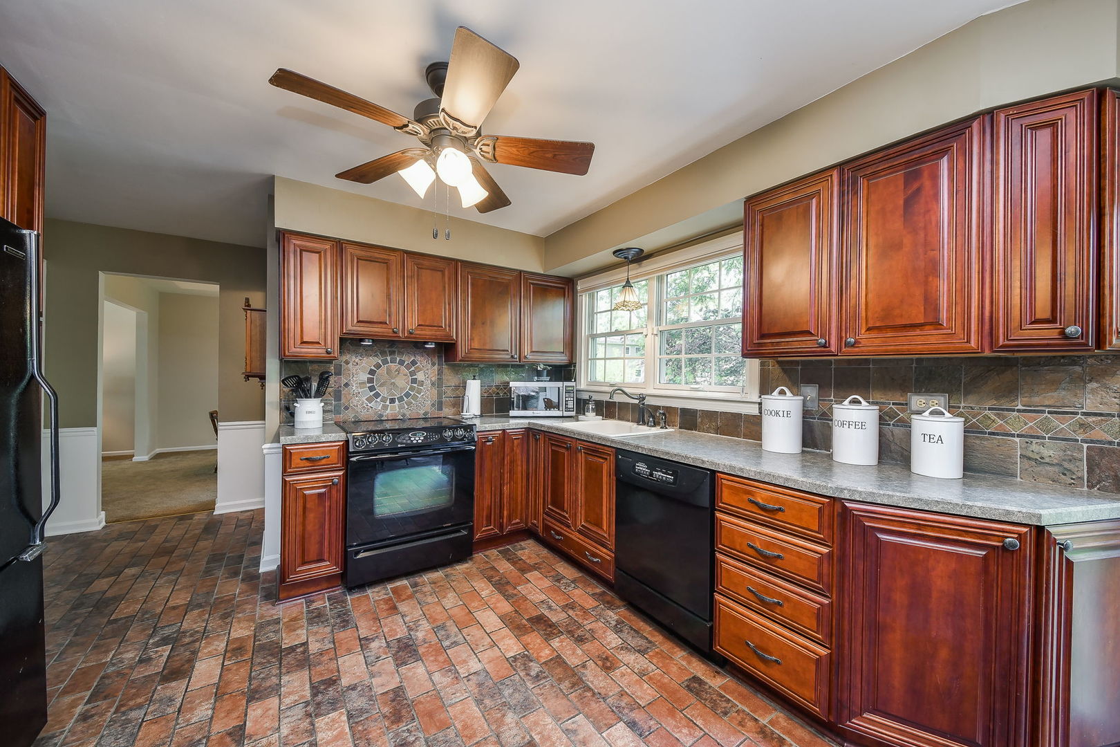 116 West Bailey Road Naperville, IL 60565 - Photo 5 of 27 a kitchen with stainless steel appliances granite countertop wooden cabinets a sink a stove a refrigerator and island with wooden floor
