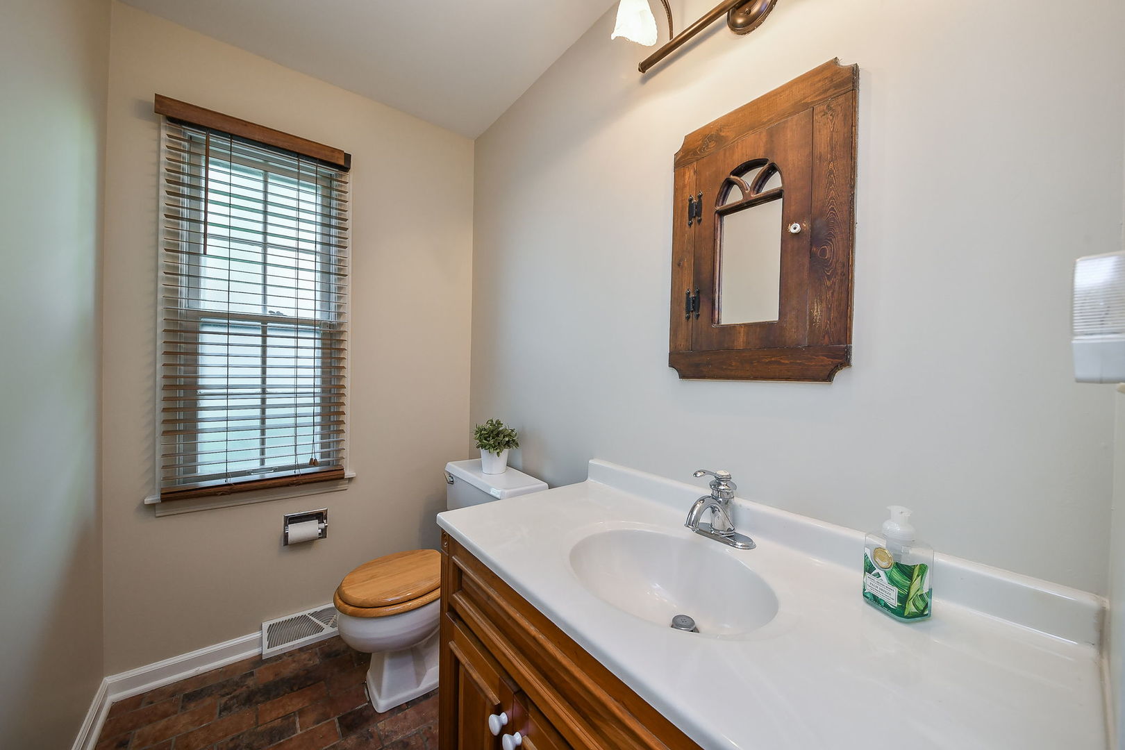 116 West Bailey Road Naperville, IL 60565 - Photo 10 of 27 a bathroom with a sink a toilet and mirror