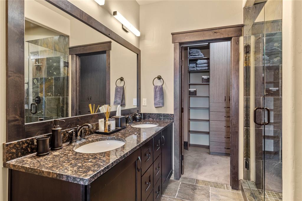 874 Independence Road, Unit 874 Keystone, CO 80435 - Photo 24 of 35 a bathroom with a granite countertop sink and a mirror