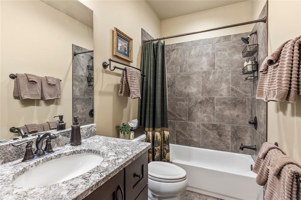 874 Independence Road, Unit 874 Keystone, CO 80435 - Photo 25 of 35 a bathroom with a granite countertop sink toilet and shower
