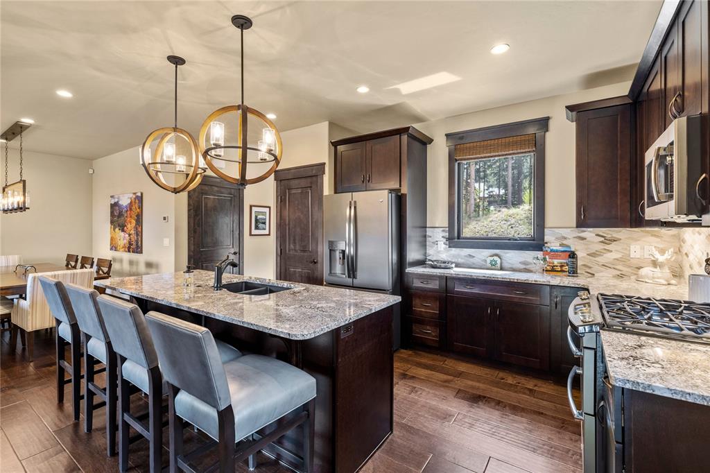 874 Independence Road, Unit 874 Keystone, CO 80435 - Photo 9 of 35 a dining table with chairs and kitchen view