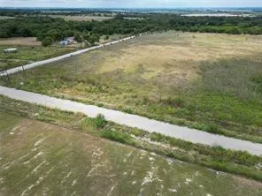 a view of a field with an ocean