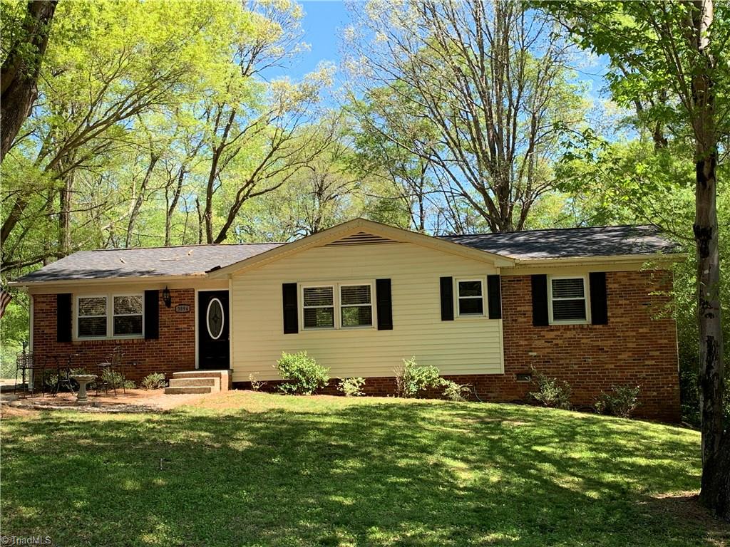 3896 Lewiston Road Summerfield, NC 27358 - Photo 1 of 16 Nestled among massive hardwoods, this brick & vinyl exterior makes for no maintenance!
