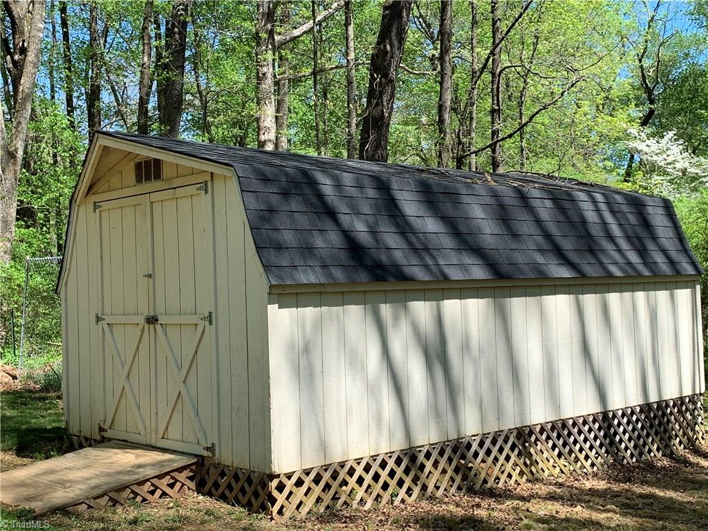 3896 Lewiston Road Summerfield, NC 27358 - Photo 16 of 16 Large storage building for all your gardening tools.