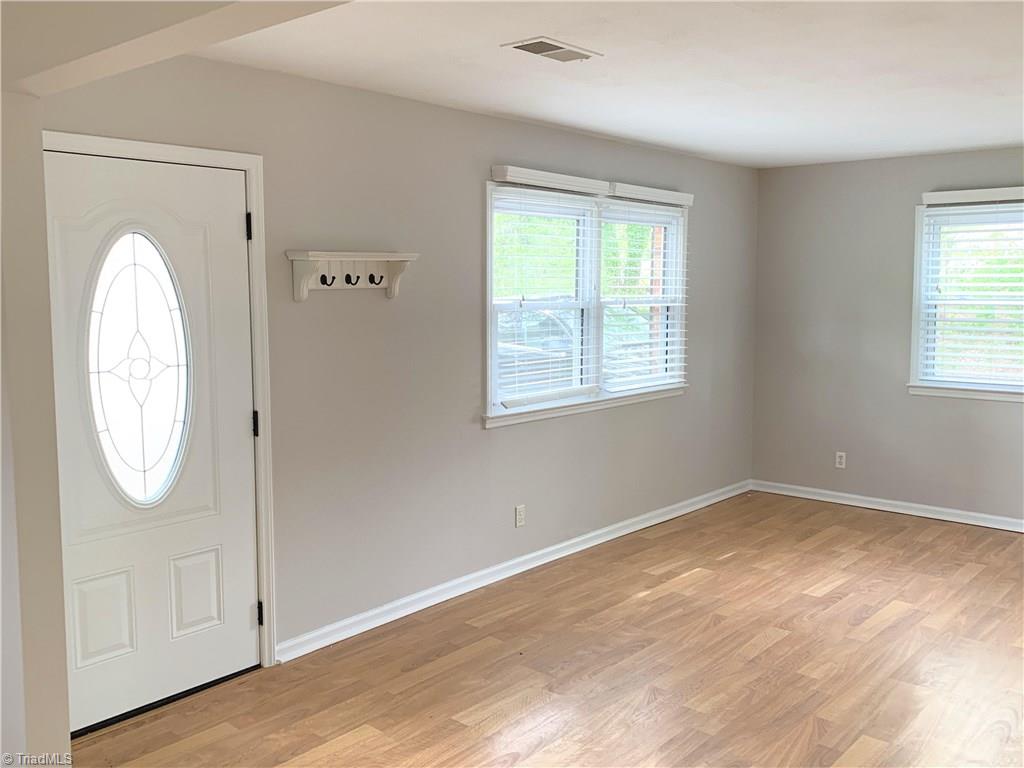 3896 Lewiston Road Summerfield, NC 27358 - Photo 3 of 16 No carpets to deal with here! Beautiful laminate flooring in all the living areas. Hardwood in the bedrooms.