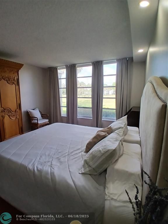 907 Cypress Terrace, Unit 104 Pompano Beach, FL 33069 - Photo 14 of 40 a bedroom with a bed and window