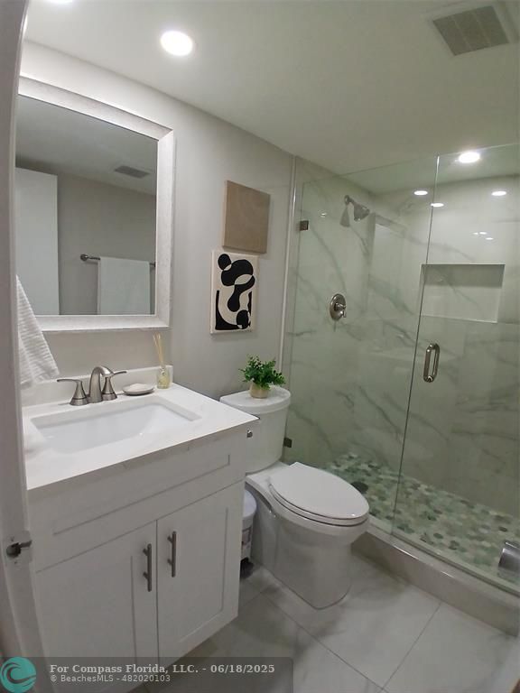 907 Cypress Terrace, Unit 104 Pompano Beach, FL 33069 - Photo 17 of 40 a bathroom with a sink toilet and shower