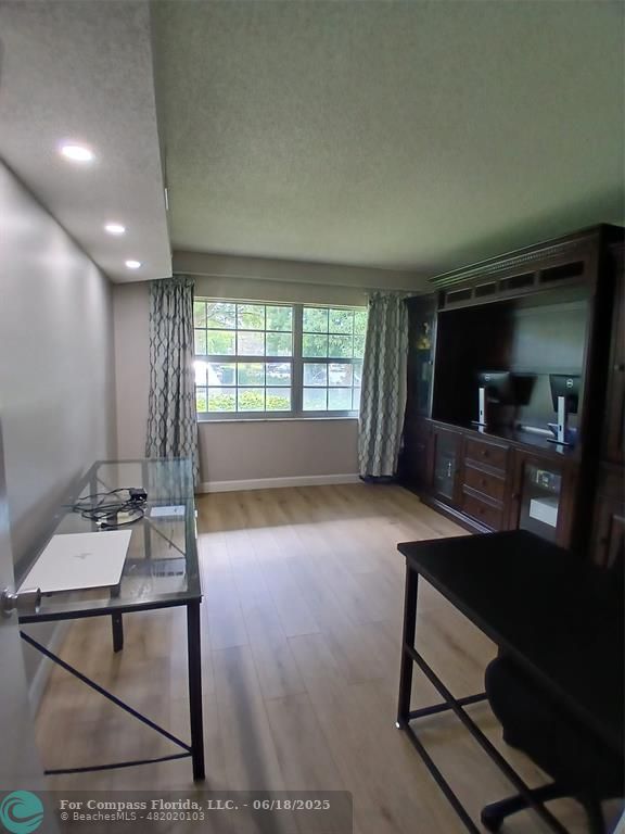 907 Cypress Terrace, Unit 104 Pompano Beach, FL 33069 - Photo 21 of 40 a room with furniture and window