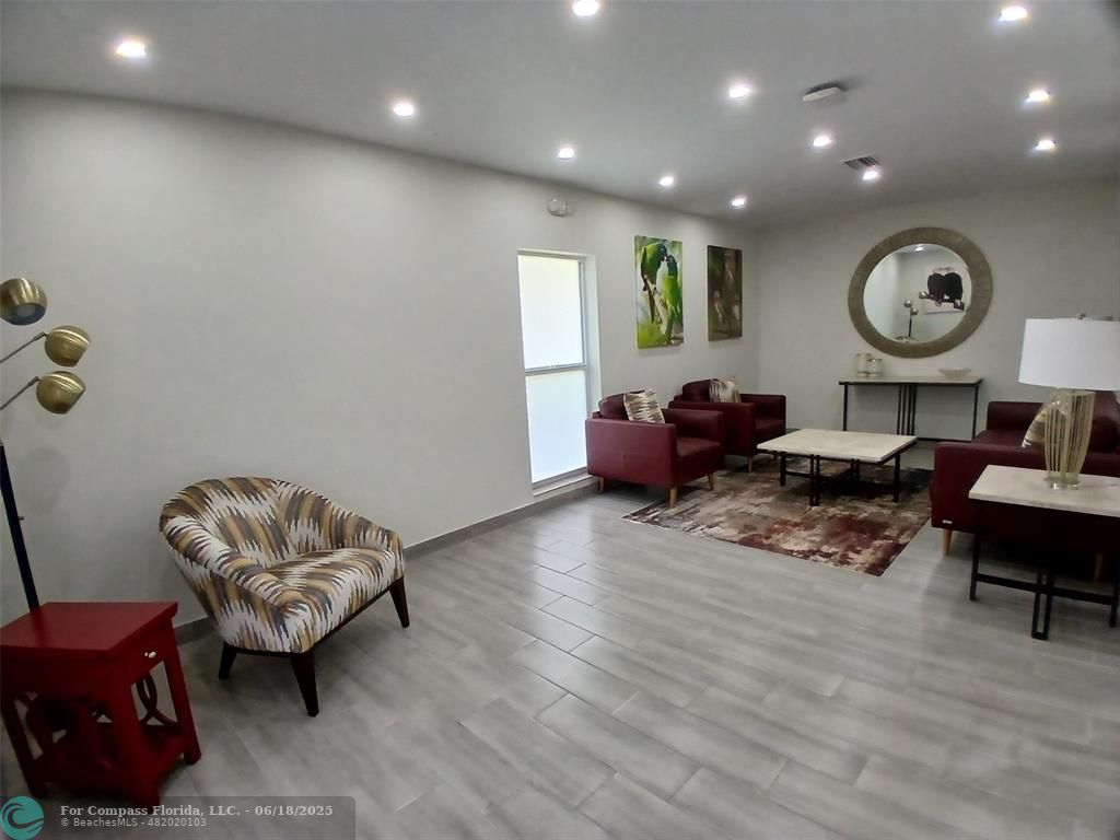 907 Cypress Terrace, Unit 104 Pompano Beach, FL 33069 - Photo 37 of 40 a living room with furniture and a wooden floor