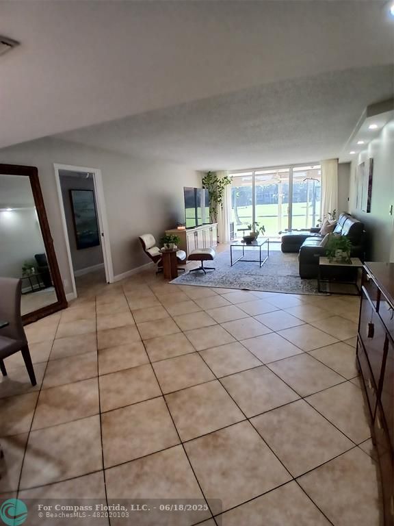 907 Cypress Terrace, Unit 104 Pompano Beach, FL 33069 - Photo 7 of 40 a view of a livingroom with furniture and windows