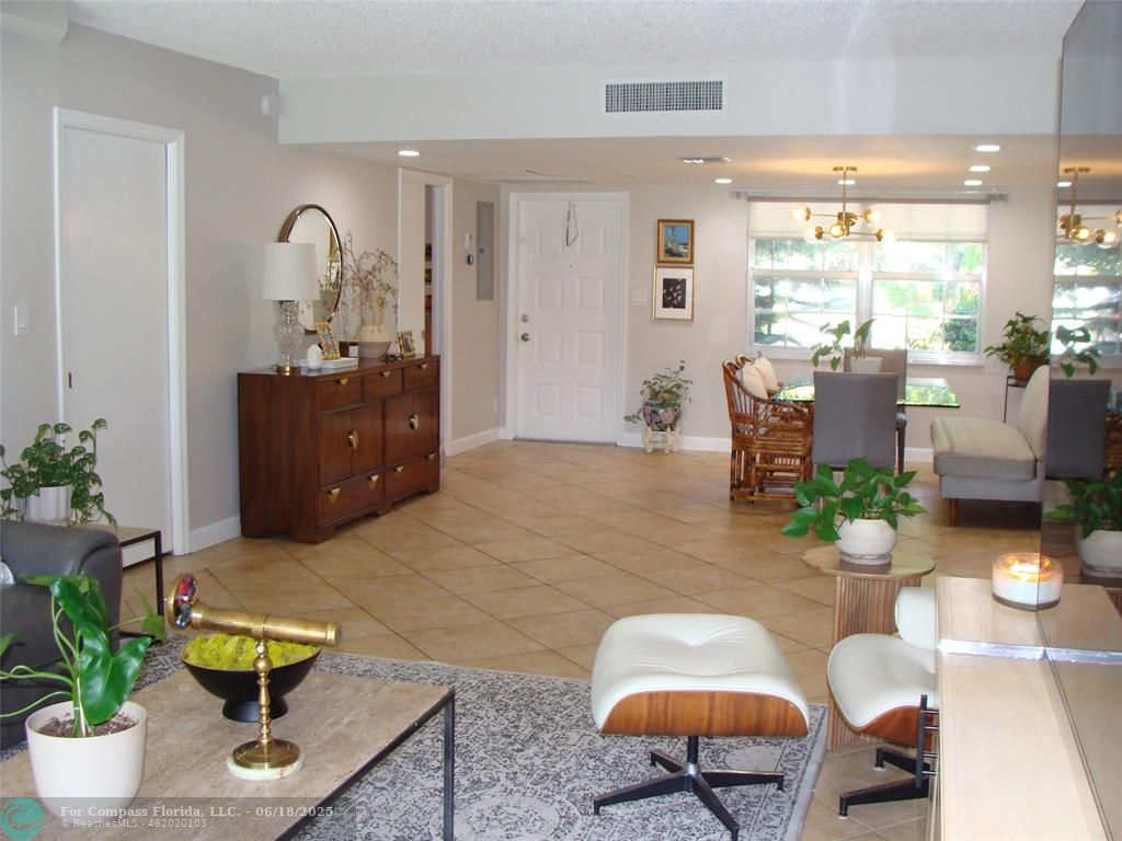 907 Cypress Terrace, Unit 104 Pompano Beach, FL 33069 - Photo 8 of 40 a living room with furniture potted plant and a window