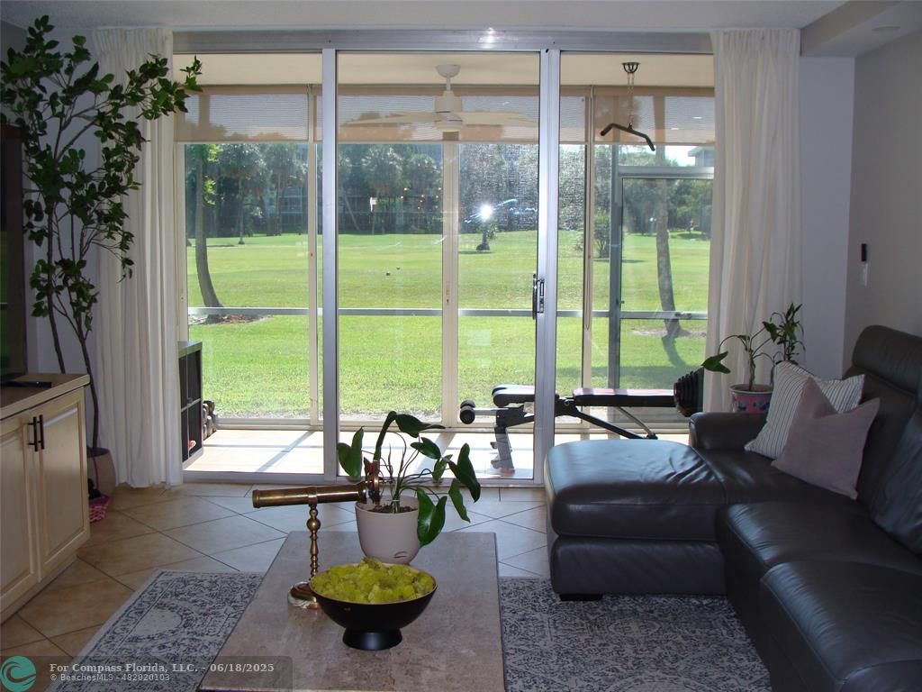 907 Cypress Terrace, Unit 104 Pompano Beach, FL 33069 - Photo 10 of 40 a living room with furniture and a large window