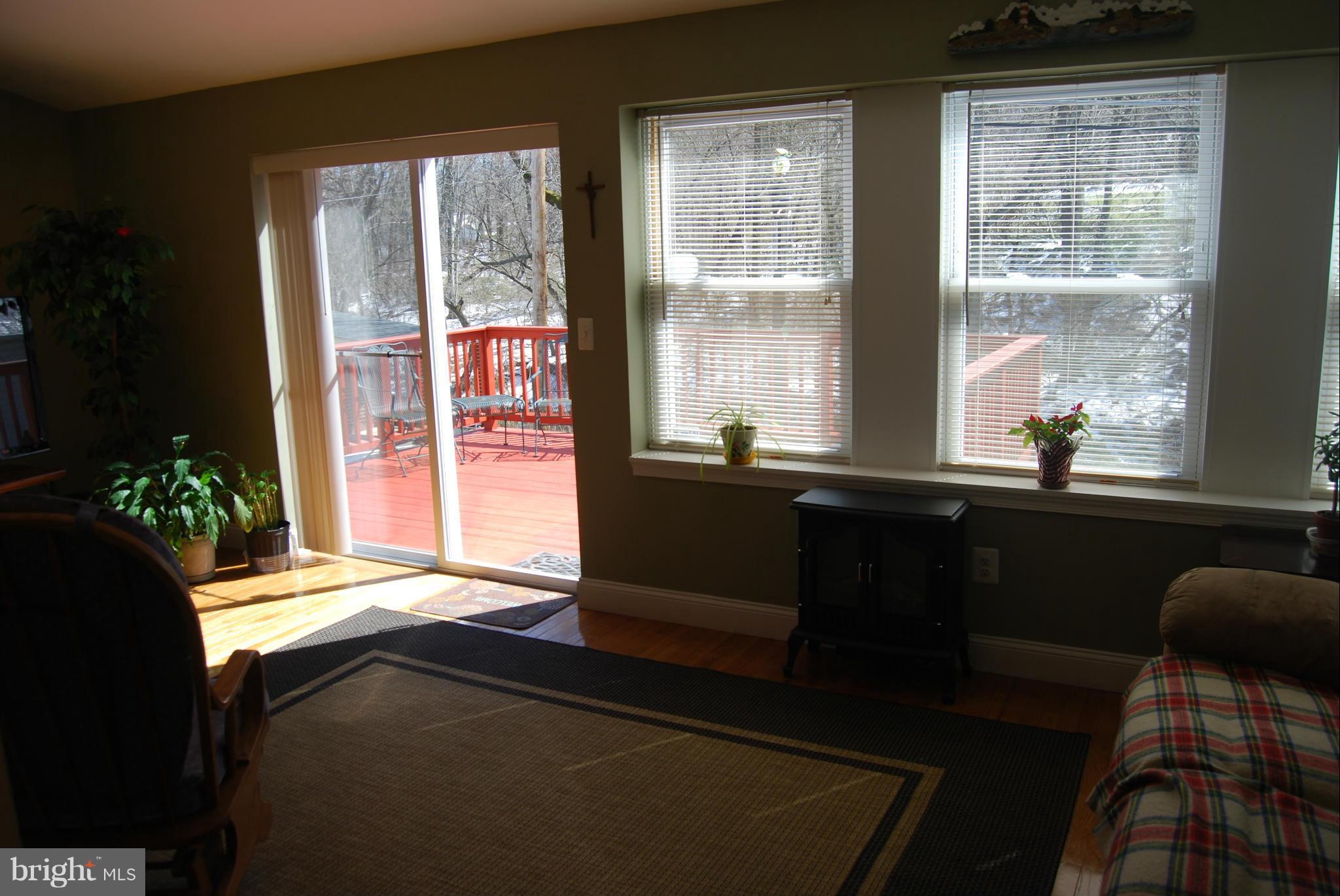 8127 Woodhaven Road Baltimore, MD 21237 - Photo 14 of 29 Light filled sunroom w/sliders to the deck