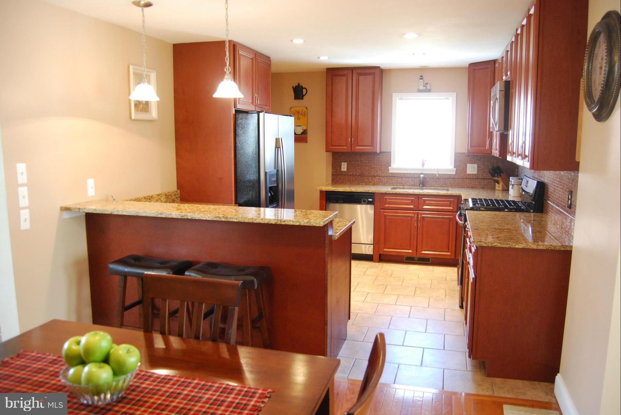 8127 Woodhaven Road Baltimore, MD 21237 - Photo 9 of 29 Kitchen w/cherry cabinetry and granite tops