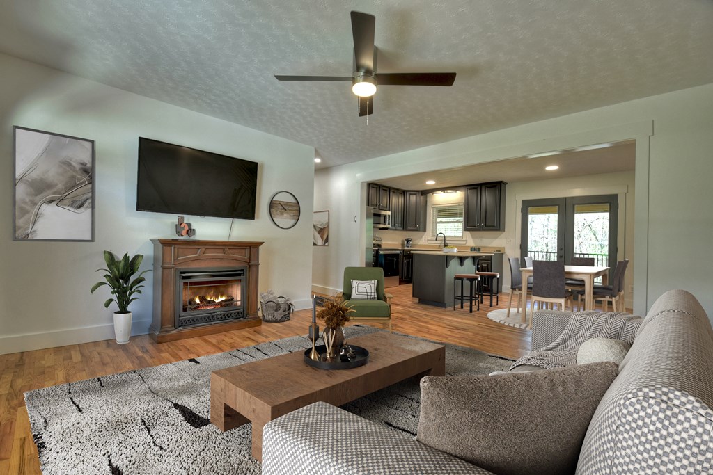 975 Goss Road Epworth, GA 30541 - Photo 13 of 59 a living room with furniture a flat screen tv and a fireplace