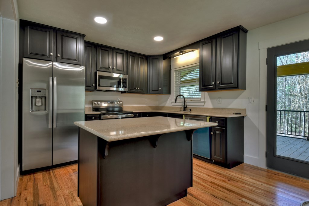 975 Goss Road Epworth, GA 30541 - Photo 18 of 59 a kitchen with stainless steel appliances granite countertop a sink stove and refrigerator