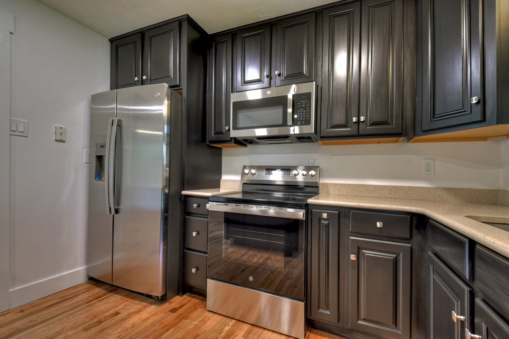 975 Goss Road Epworth, GA 30541 - Photo 19 of 59 a kitchen with granite countertop cabinets stainless steel appliances and wooden floor