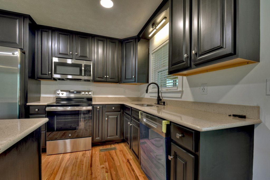 975 Goss Road Epworth, GA 30541 - Photo 20 of 59 a kitchen with granite countertop stainless steel appliances and sink