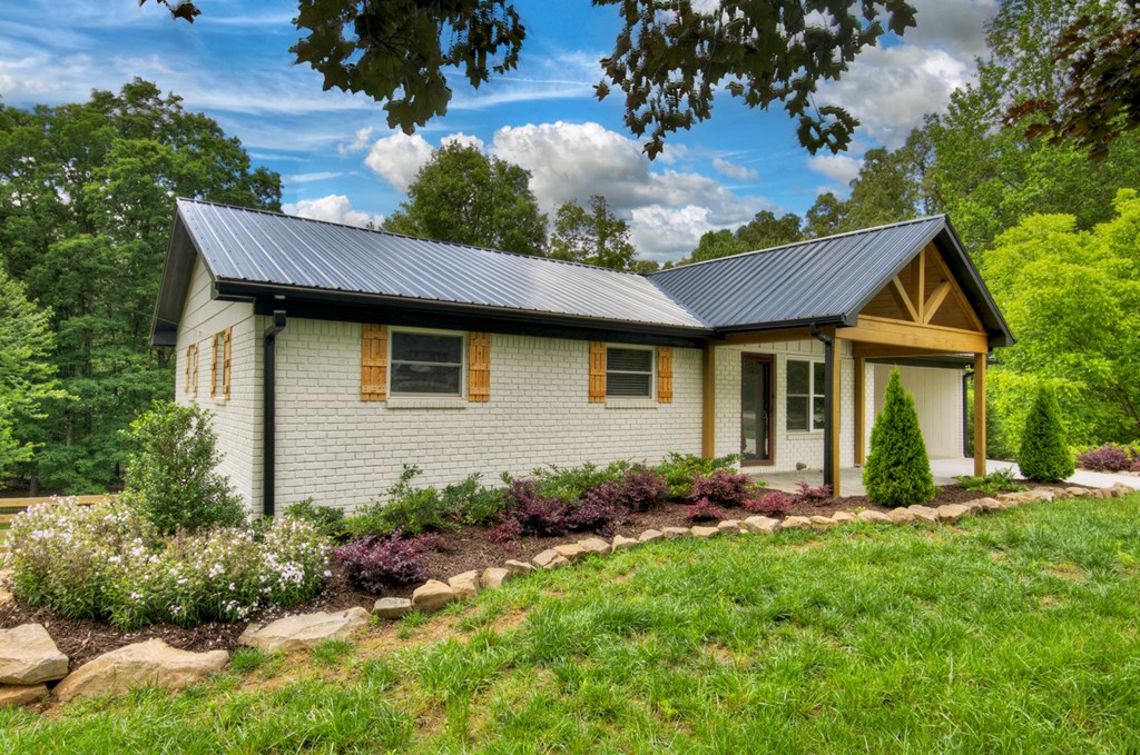 975 Goss Road Epworth, GA 30541 - Photo 2 of 59 a front view of a house with a garden