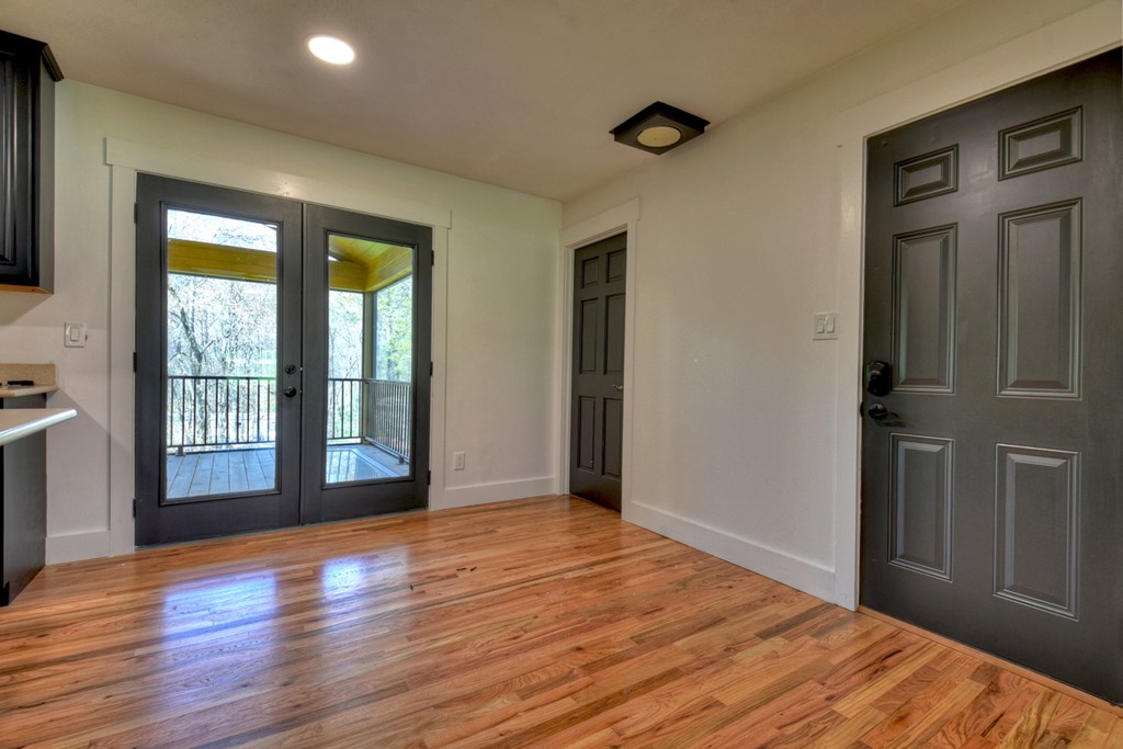 975 Goss Road Epworth, GA 30541 - Photo 22 of 59 a view of an empty room with wooden floor and a window