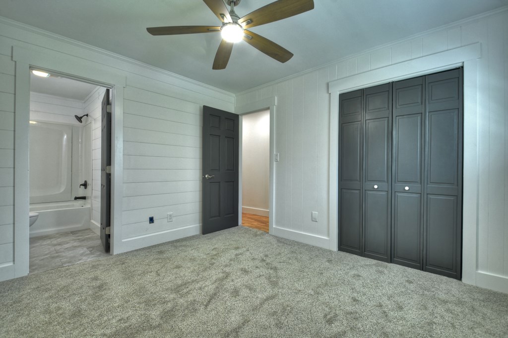 975 Goss Road Epworth, GA 30541 - Photo 26 of 59 an empty room with closet and a chandelier fan