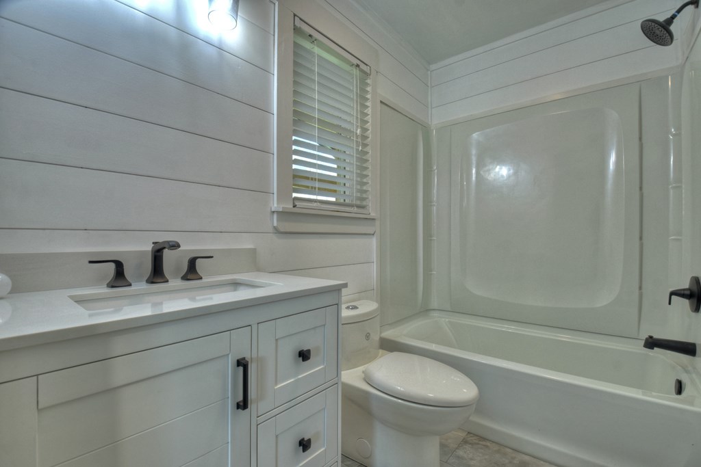 975 Goss Road Epworth, GA 30541 - Photo 27 of 59 a bathroom with a granite countertop sink toilet mirror and bathtub