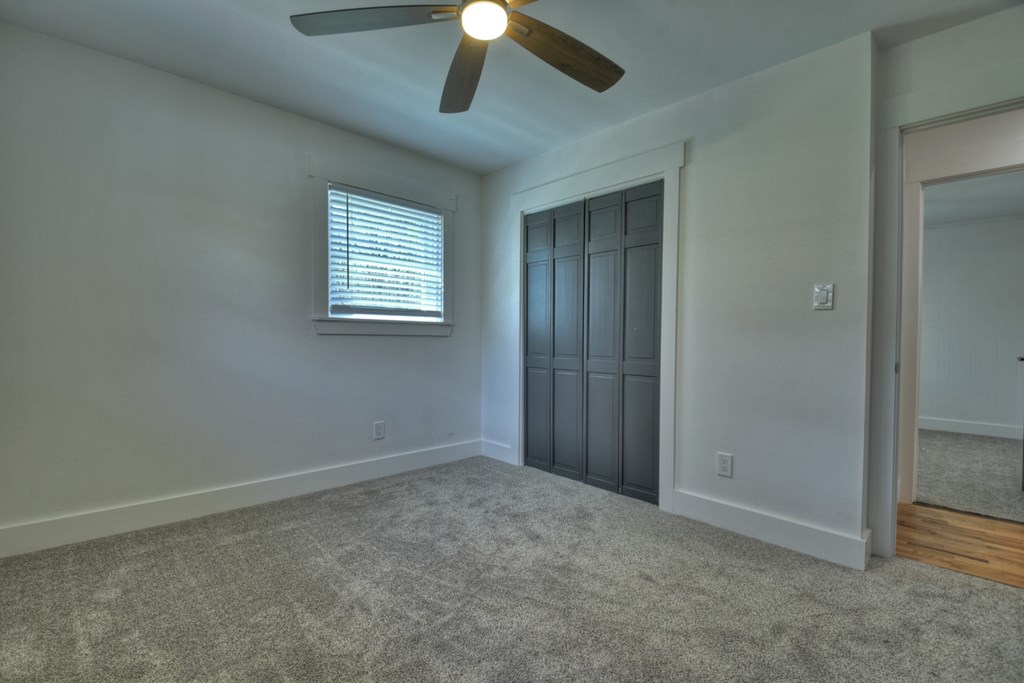 975 Goss Road Epworth, GA 30541 - Photo 30 of 59 an empty room with a ceiling fan and a window