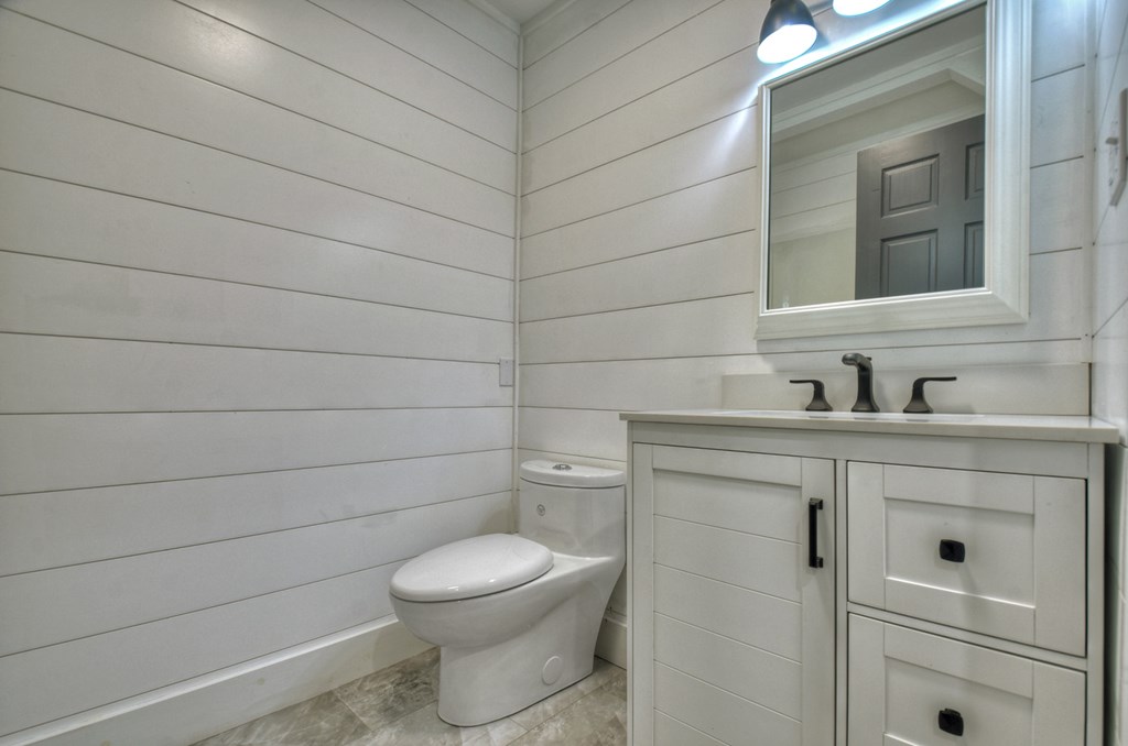 975 Goss Road Epworth, GA 30541 - Photo 31 of 59 a bathroom with a toilet sink vanity and mirror