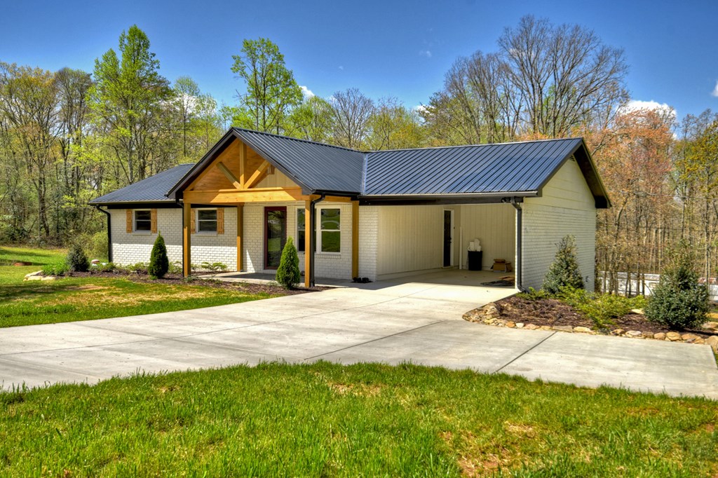 975 Goss Road Epworth, GA 30541 - Photo 48 of 59 a front view of a house with a garden and porch
