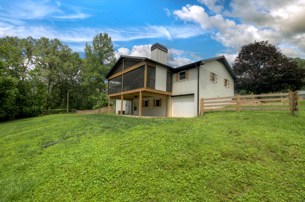 975 Goss Road Epworth, GA 30541 - Photo 57 of 59 a view of a wooden house with a big yard and large trees